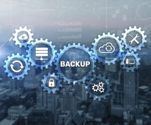 Image of technology functions in gears overlapping city building background, BACKUP shows in large center gear